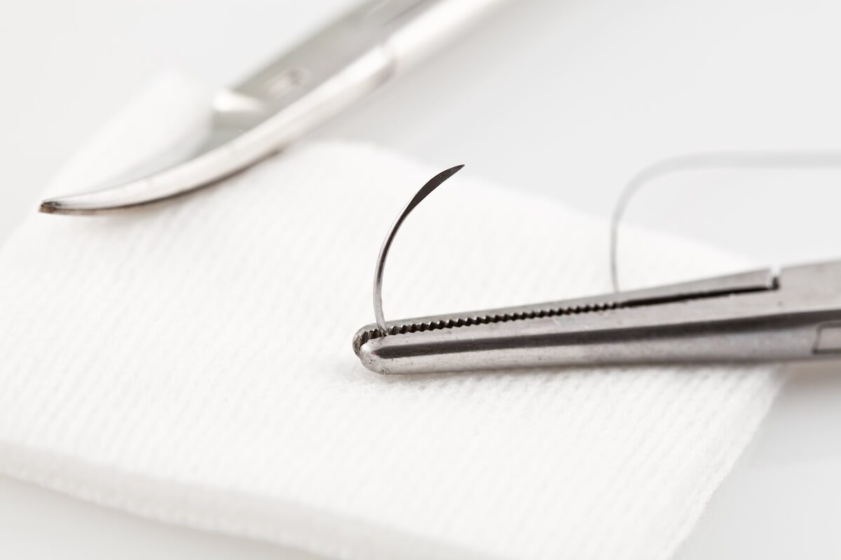Silk surgical suture and scissors